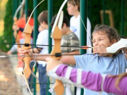 Children Practicing Archery - stock photo
