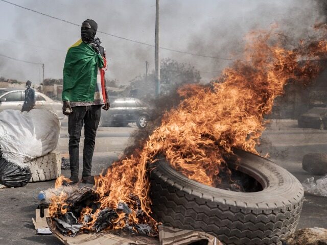 DAKAR, SENEGAL - MARCH 16: Senegal's opposition leader and presidential candidate Ousmane Sonko's supporters stage a demonstration and close the roads to traffic burning tires as he went to court to attend the hearing, on March 16, 2023 in Dakar, Senegal. Ousmane Sonko, who is on trial in Senegal for …