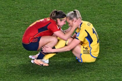 Sweden's forward Fridolina Rolfo (R) is consoled by Spain's Mariona Caldentey